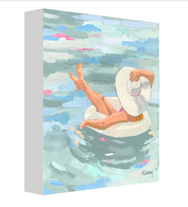 Kristin Cooney's fine art print from her Bathing Beauties collection, inspired by 1950's beach fashion and femininity. The HANNAH fine art print by Kristin Cooney—featuring a glamorous woman in a pink swimsuit and sunhat, gracefully lounging in a pool float. A nod to vintage glamour with free U.S. shipping and multiple size options. Created from an original painting by Kristin Cooney.