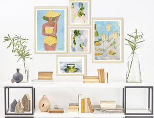 A gallery wall of artwork from Kristin Cooney Studio. Art print titled SUNNY OUTLOOK from the BATHING BEAUTIES COLLECTION by Kristin Cooney , artwork of glamorous woman in yellow bathing suit and hat. Free US Shipping, faming options.  Created from an original painting by Kristin Cooney
